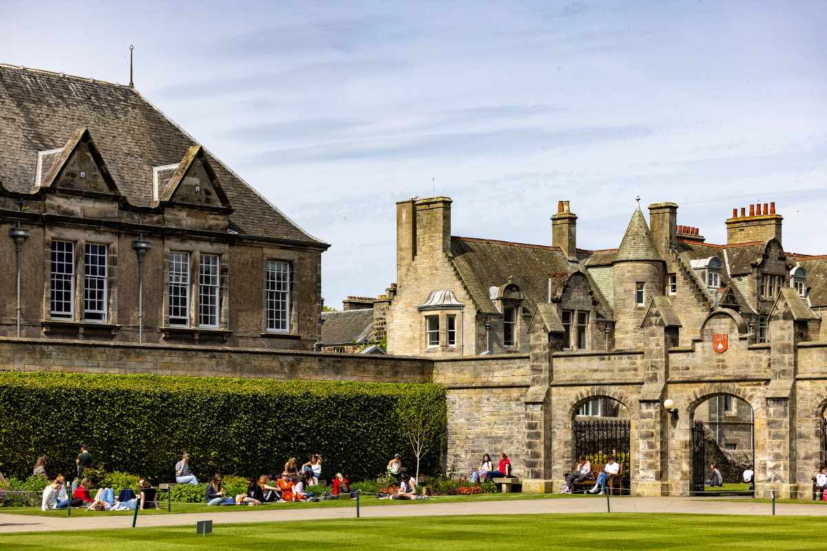 St Salvator's Quad in the sunshine. Students sit across benches and on the grass enjoying the sun St Salvator's Quad in the sunshine. Students sit across benches and on the grass enjoying the sun