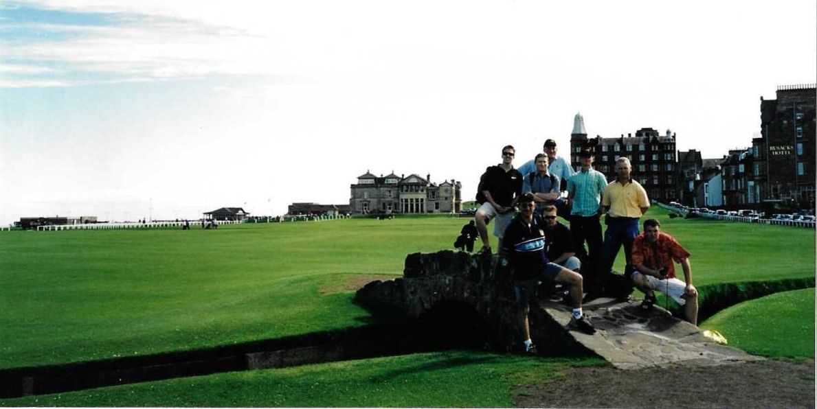 A group of eight men stand on the Swilcan Bridge, St Andrews. A group of eight men stand on the Swilcan Bridge, St Andrews.