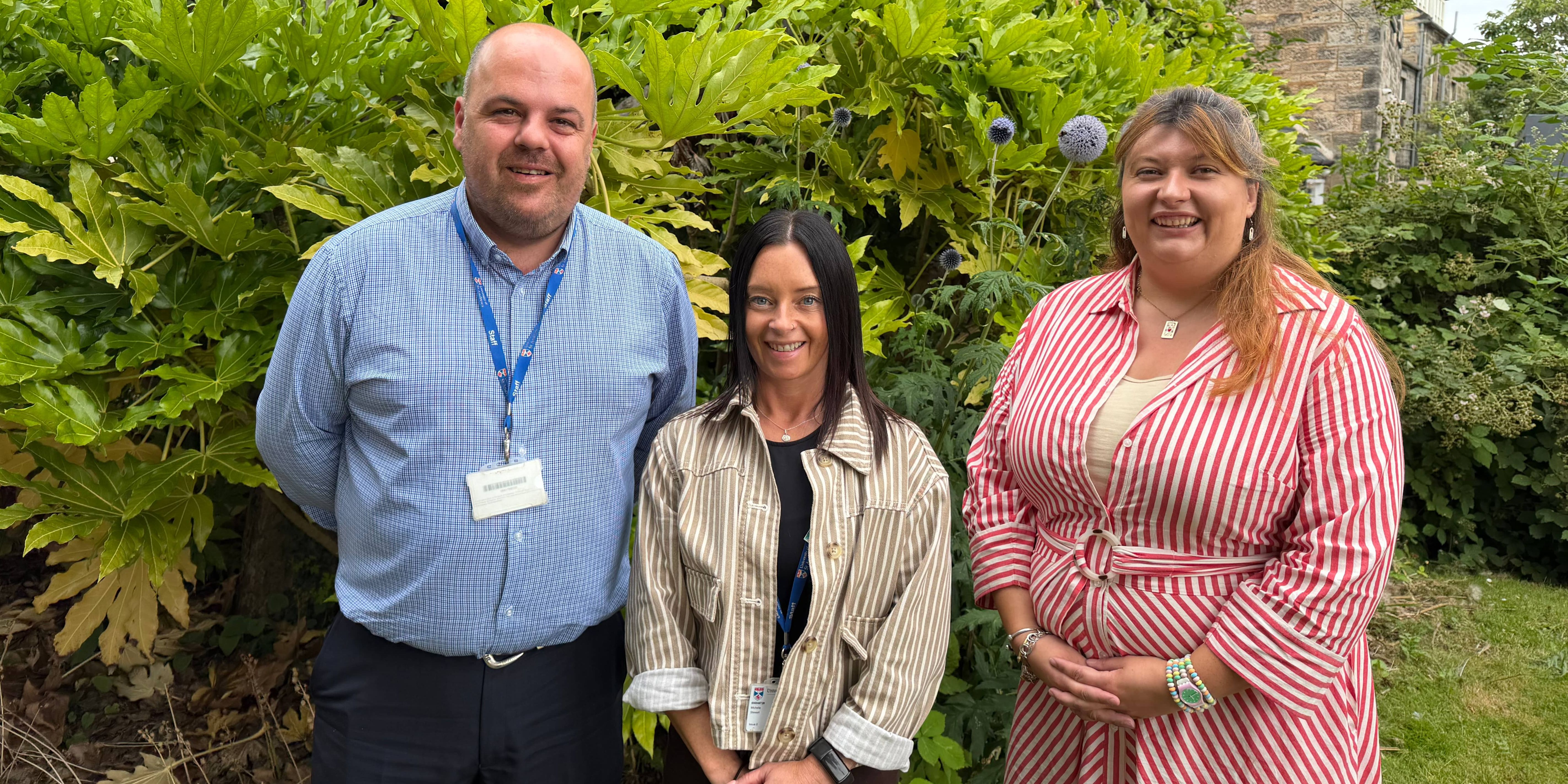 Edward Findlay, Michelle Stewart and Rachel McEwen pose smiling for a group photo in front of green foliage Edward Findlay, Michelle Stewart and Rachel McEwen pose smiling for a group photo in front of green foliage